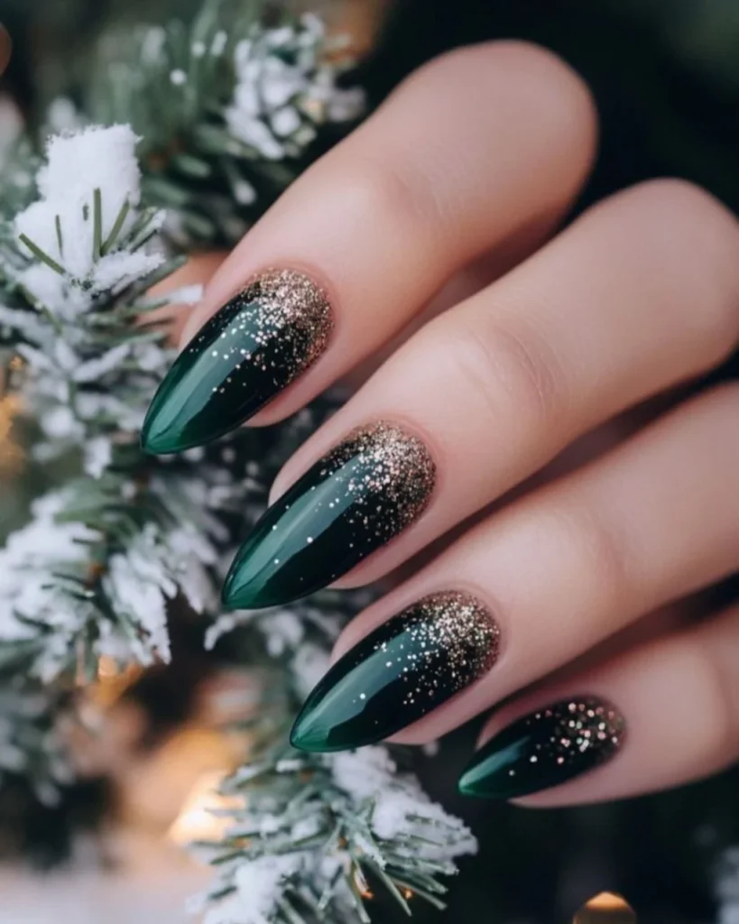 Christmas glitter ombre nails featuring deep forest green almond-shaped nails with fine gold glitter fading from the tips toward the center