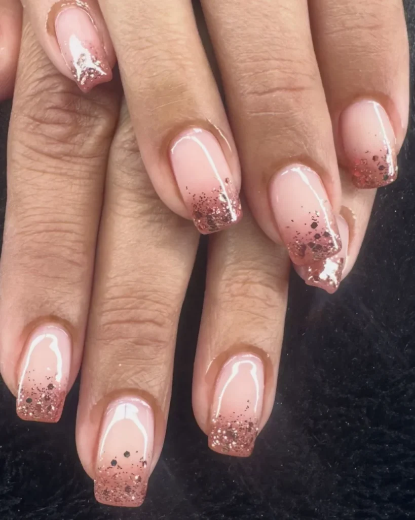 Christmas glitter ombre nails featuring a blush pink base fading into rose gold glitter tips on square-shaped nails.