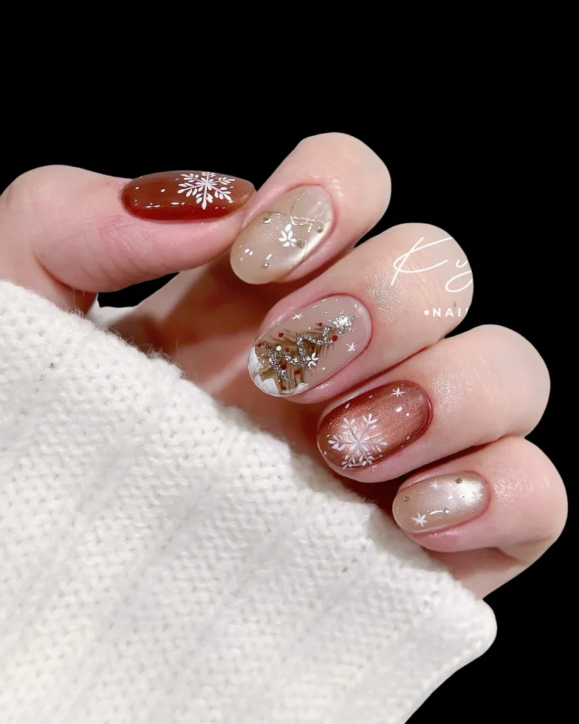 Classy Christmas short nail designs featuring nude and caramel polish, delicate white snowflakes, tiny gold accents, and festive Christmas tree art.