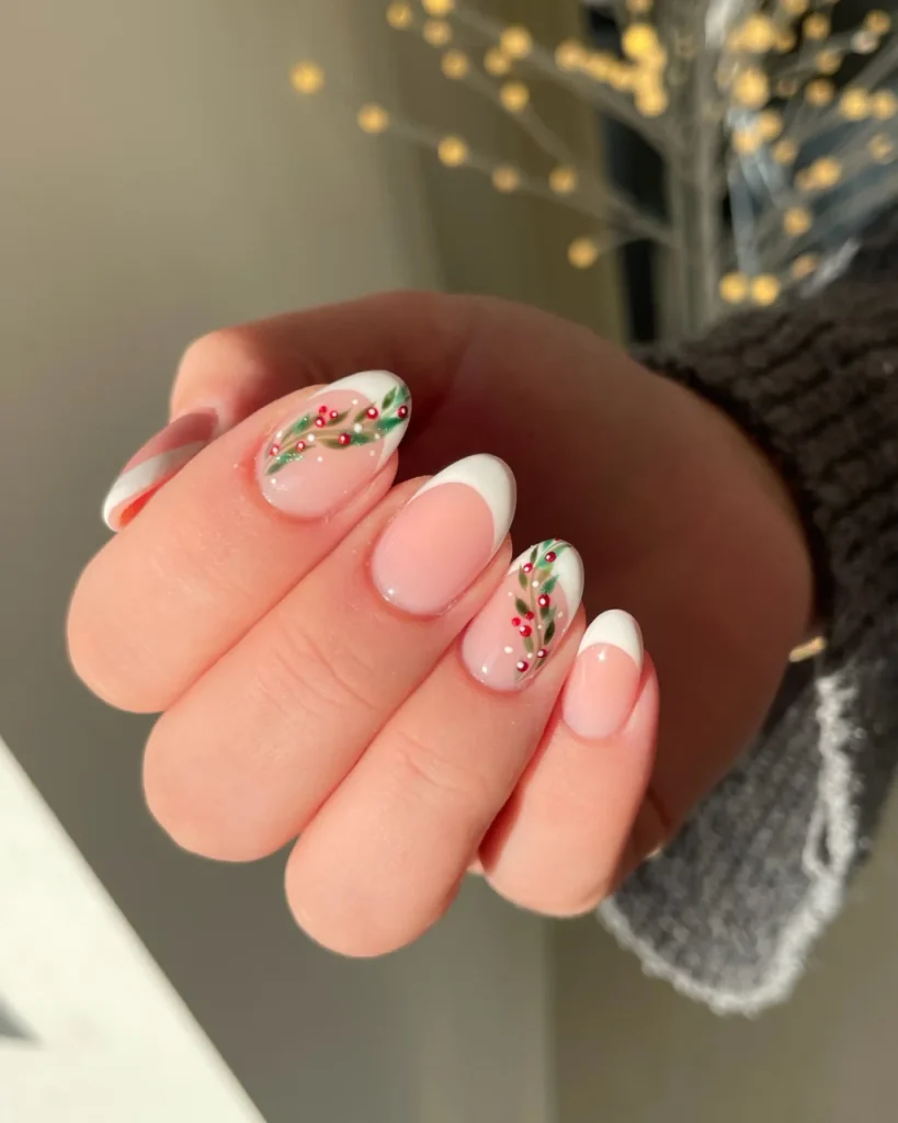 French manicure Christmas nail designs with pink oval nails, white French tips, green holly branches, and tiny red berries.