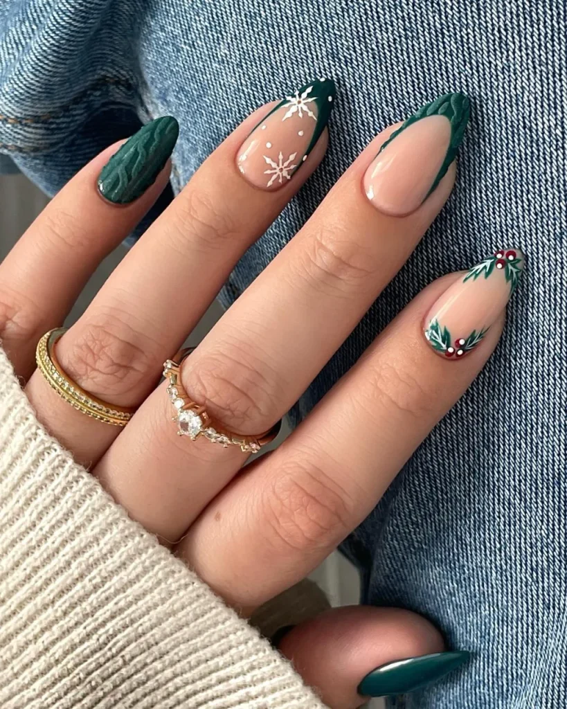 Green Christmas French tip nail designs with emerald green tips, white snowflakes, and holly berry nail art on a nude pink base.