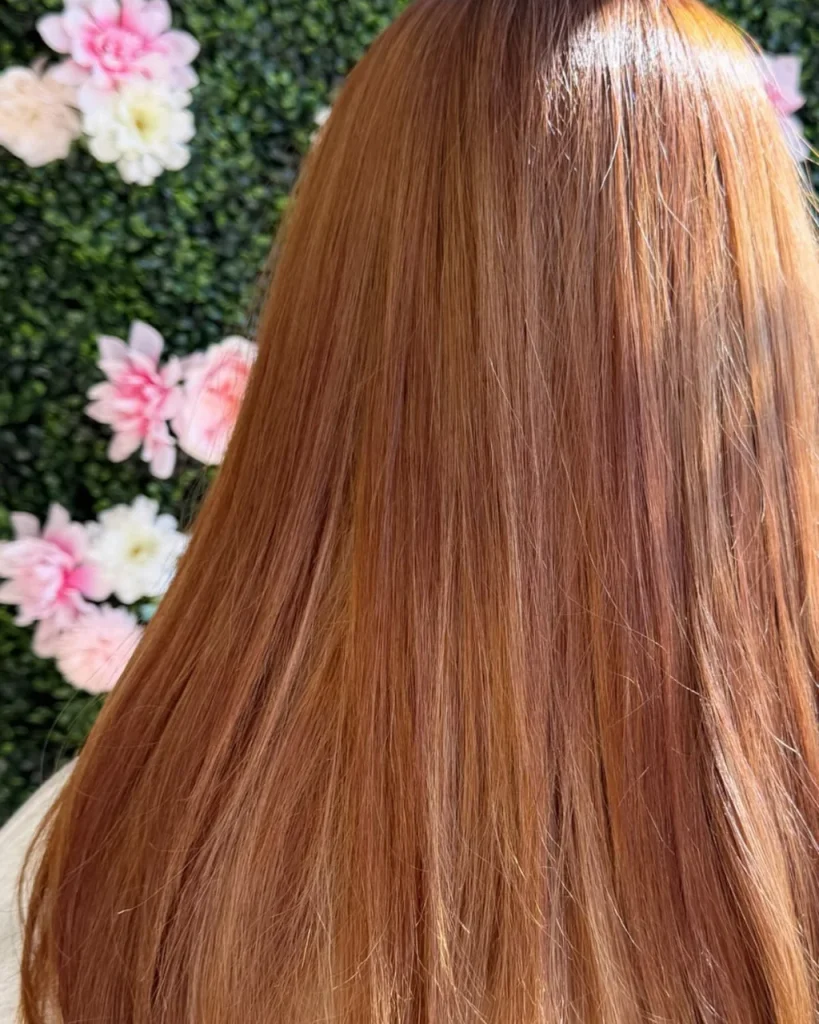 Long straight light brown cinnamon hair with warm copper and golden tones