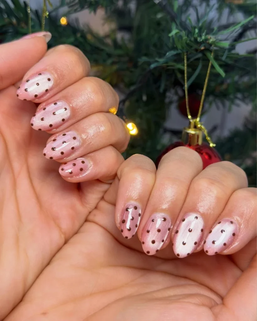 Light pink Christmas nails with charming festive accents, delicate holiday-inspired nail art, and a soft, sophisticated pink finish.