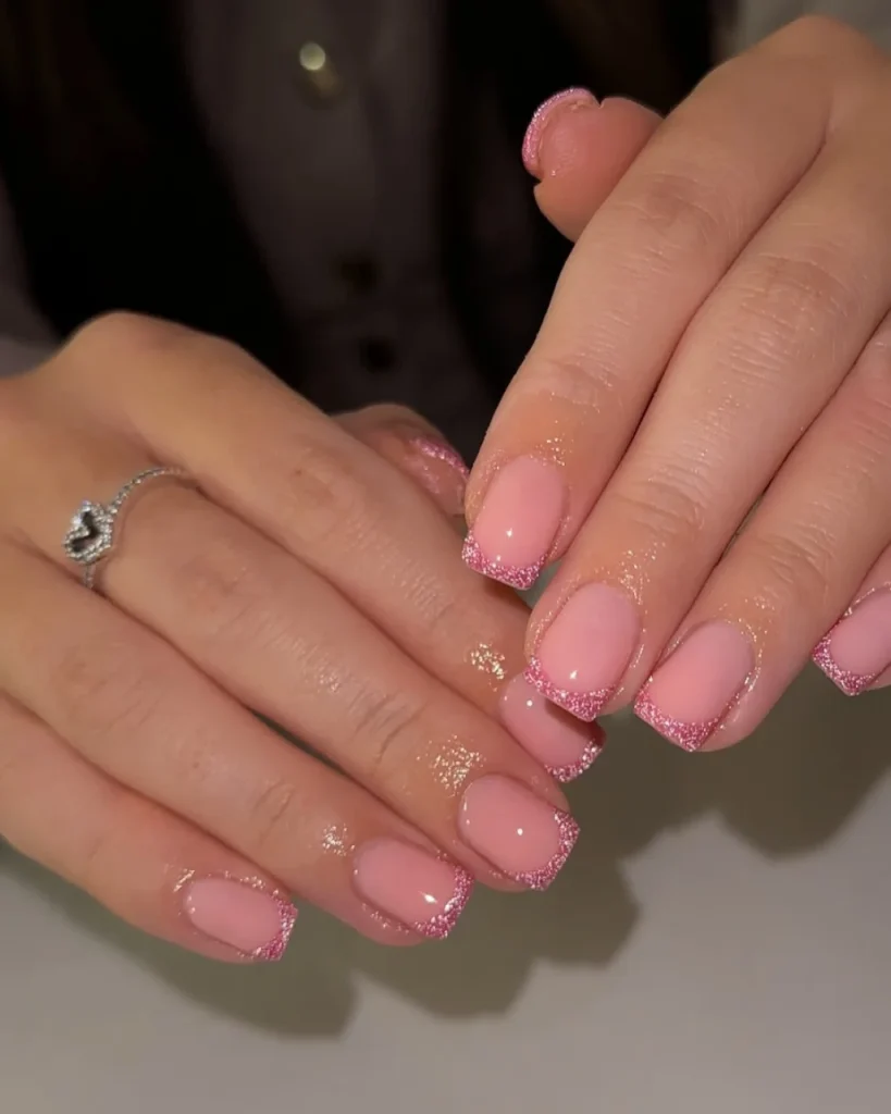 Light pink Christmas nails featuring cute festive holiday art, delicate pink polish, and charming seasonal details for a feminine Christmas manicure.