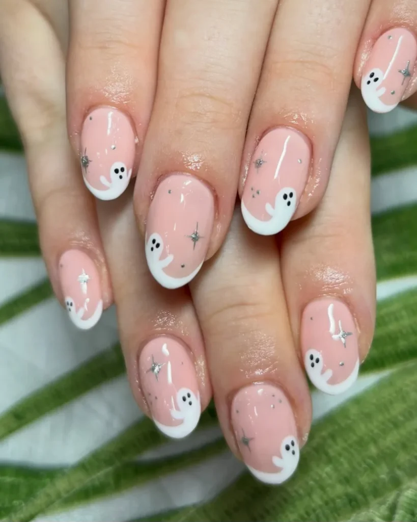 Light pink Christmas nails with elegant festive details, featuring soft pink polish and delicate Christmas-inspired nail art.