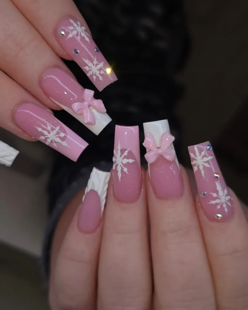 Light pink Christmas nails featuring sparkling festive nail art, delicate holiday accents, and a soft, elegant finish.