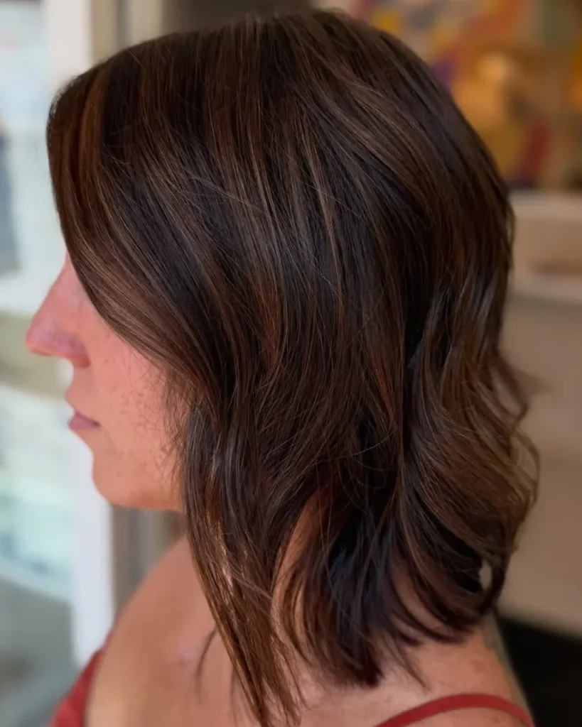 Medium length brown hair with a chocolate brown lob, soft layers, and subtle warm highlights.