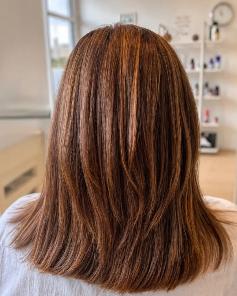 Medium length light brown style with a glossy, all-over brown shade and softly layered ends.
