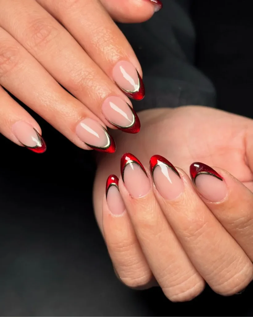 Metallic Red Cat-Eye French Tips with glossy nude-pink nails, shimmering red tips, and thin metallic gold outlines.