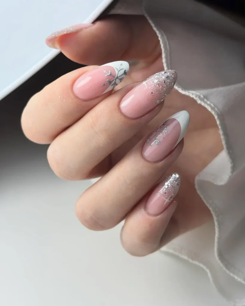 Pink and white French tip Christmas nail designs with silver snowflakes and sparkling glitter accents.