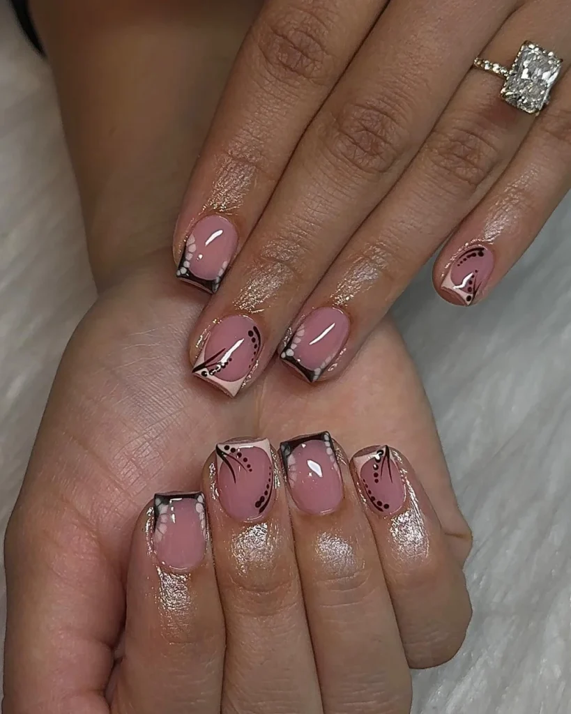 Short french tip christmas nail designs featuring dusty pink square nails with black and white geometric French tips, delicate dotted accents, fine curved line art, and glossy finishes, offering a creative take on white french tip christmas nail designs.