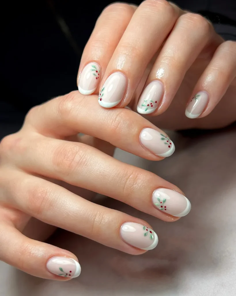 Short french tip christmas nail designs featuring milky white nails, soft white French tips, and delicate green holly leaves with red berries, creating elegant white french tip christmas nail designs for the holiday season.
