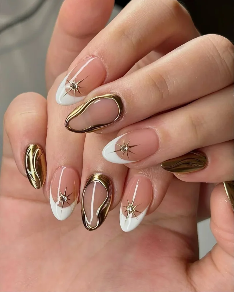 White french tip christmas nail designs with sheer pink bases, white tips, gold chrome accents, and delicate starburst details.